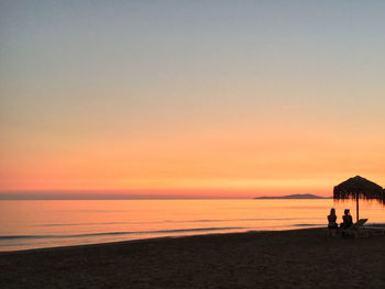 Scenic view of beach against sky during sunset