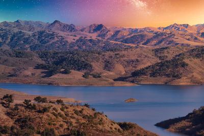 Scenic view of lake against sky during sunset