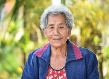 Portrait of smiling senior woman in park
