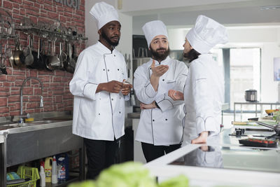 Chefs talking in kitchen