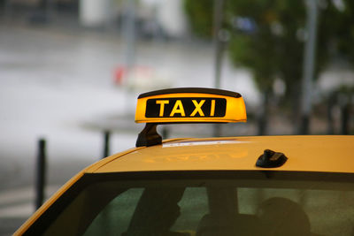 Close-up of yellow sign on street