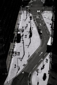 High angle view of people walking on road in city