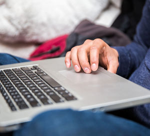 Midsection of man using mobile phone
