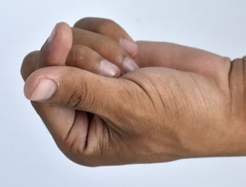 Close-up of hands over white background