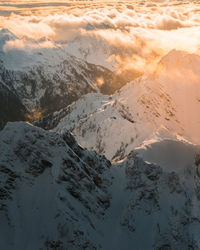 Scenic view of snowcapped mountains against sky during sunset