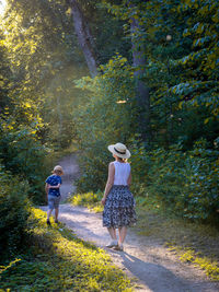 Rear view of women walking in forest