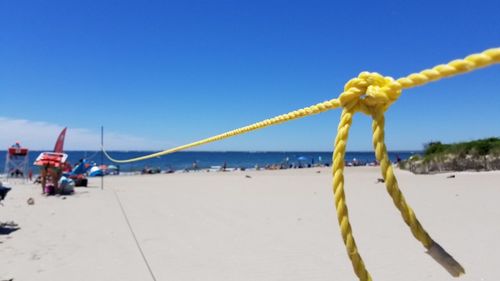 Scenic view of beach against clear blue sky