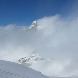 Low angle view of snowcapped mountain against sky