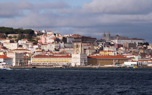 Town by sea against sky in city