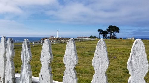 Panoramic view of wooden fence on field against sky