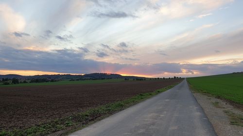 Empty road along countryside landscape