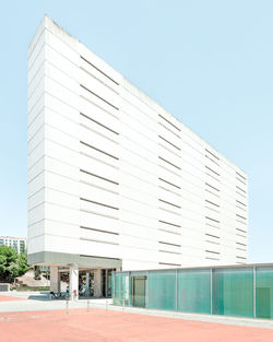 Facade of modern building against clear blue sky