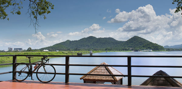 Scenic view of lake by mountains against sky