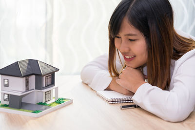 Close-up of girl looking at camera on table