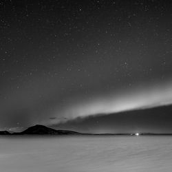 Scenic view of mountains against sky at night