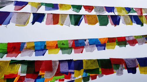 Low angle view of multi colored flags hanging