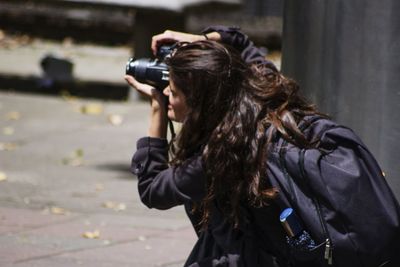 Woman photographing with camera