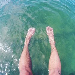 Low section of man on sea shore