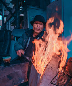 Portrait of man sitting at night