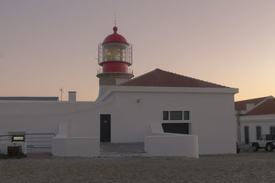 Lighthouse against clear sky during sunset