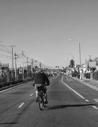 Man riding bicycle on road