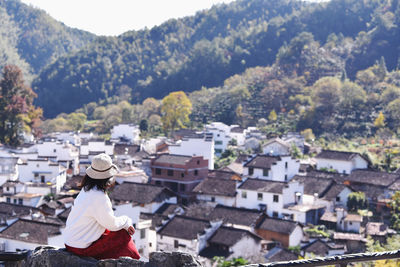 Woman looking at city buildings