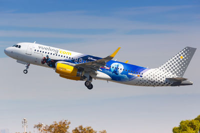 Low angle view of airplane flying against sky