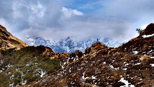 Scenic view of mountains against cloudy sky