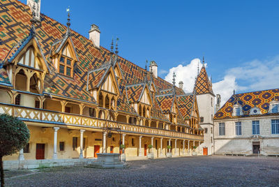 Exterior of buildings in city against clear blue sky