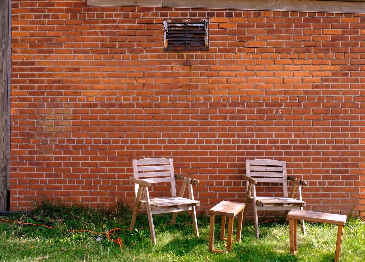 brick, brick wall, architecture, seat, built structure, chair, grass, no people, wall, building exterior, day, absence, empty, wall - building feature, nature, plant, backyard, brickwork, building, outdoors, cottage, front or back yard, wood, house, brown, table, outdoor structure, red