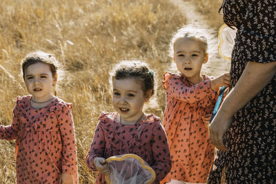 In the heart of autumn, triplets bond with mom on a net-wielding nature walk.