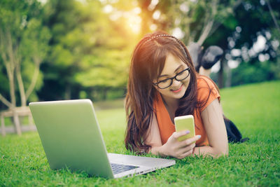 Young woman using smart phone outdoors