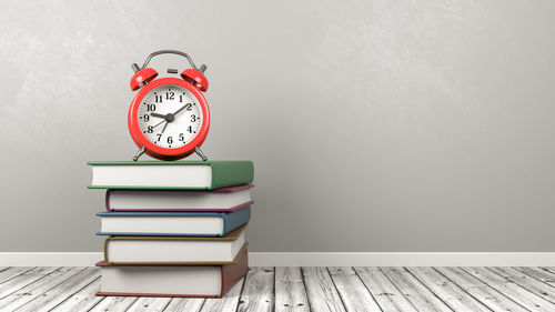 Close-up of books on table against wall