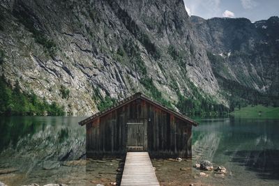 Scenic view of lake and mountains with a hut in foreground