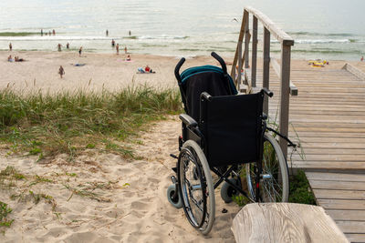 Wheelchair and stroller on ramp at the beach close up.