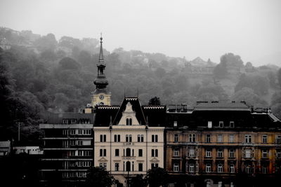 Buildings in city against sky