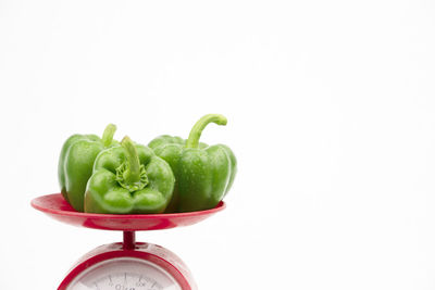 Close-up of green bell peppers against white background