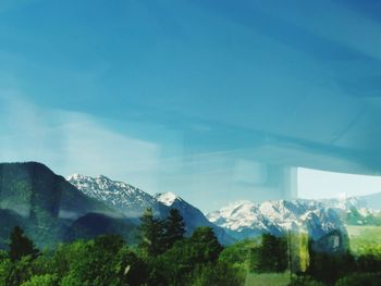 Scenic view of mountains against blue sky