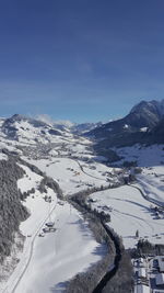 Scenic view of snow covered mountains against sky