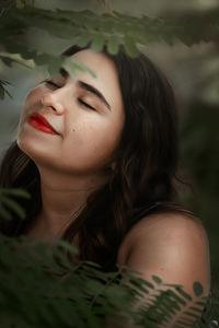 Close-up portrait of a young woman with eyes closed