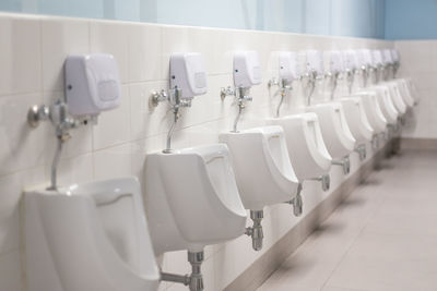 Empty urinal at public restroom
