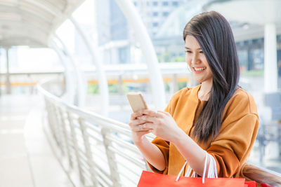 Young woman using mobile phone at home