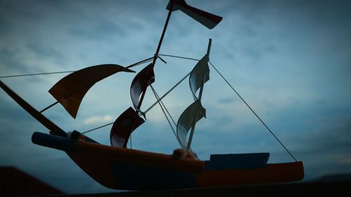 Low angle view of boat against sky at sunset