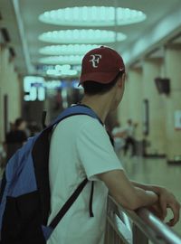 Rear view of man standing in corridor