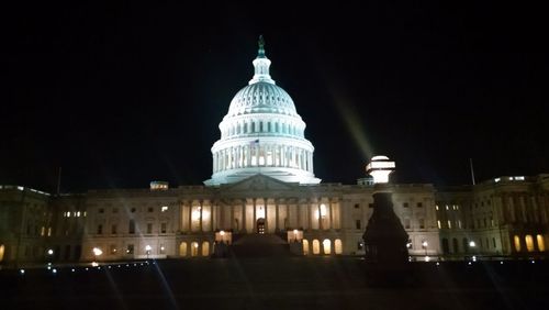 Low angle view of building lit up at night