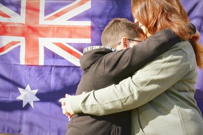 Australian mother hugs son 