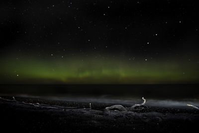Scenic view of landscape against sky at night