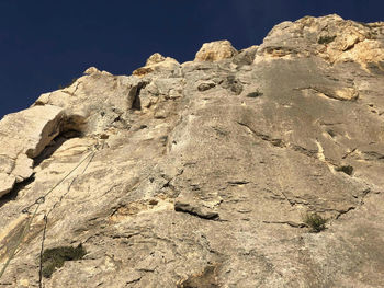 Low angle view of rock formation on land against sky