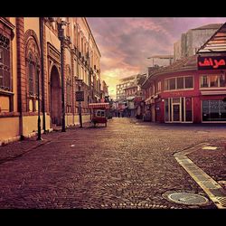 Street amidst buildings against sky in city