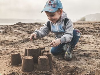 Cute boy looking at camera on beach